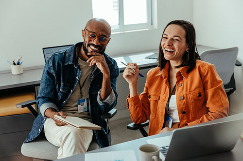 Happy co-workers smiling and collaborating in a positive office culture