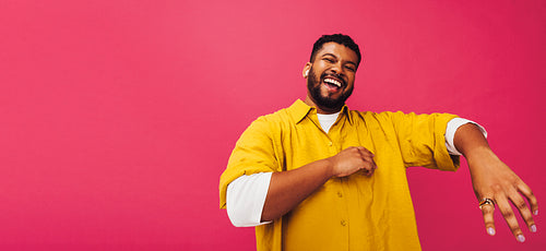 Ethnic man enjoying listening to music in a studio