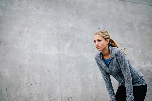 Young sports woman taking break after a run