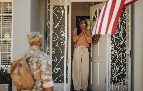 Surprised military wife welcoming her husband from the army
