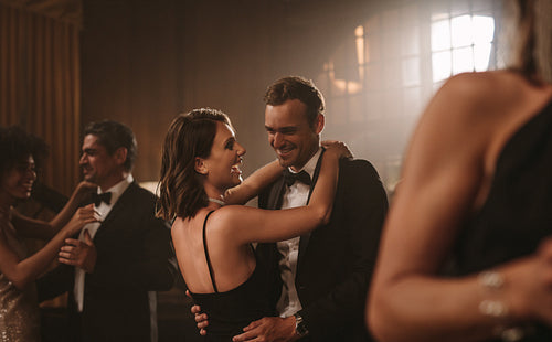 Loving young couple dancing at a party