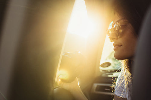 Woman traveling by a car