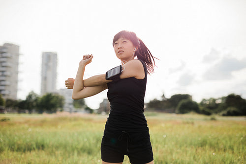 Woman stretching at urban park
