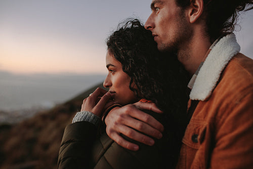 Beautiful couple looking at view from mountain