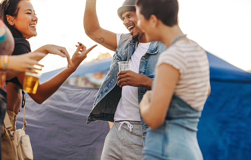 Festive moments: Friends dancing and having fun at a festival camp