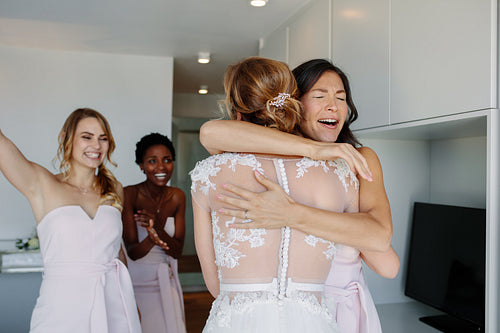 Bridesmaid congratulating the bride before wedding ceremony
