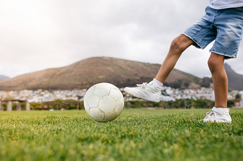 Boy playing football in a park