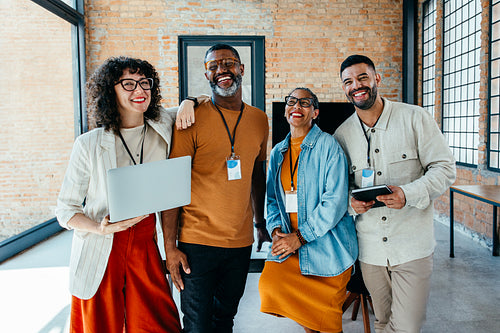 Diverse group of professionals smiling in a modern office setting