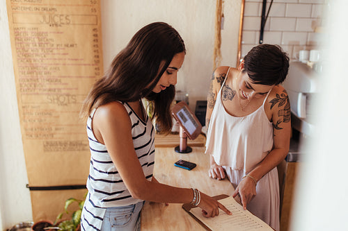 Customer looking at the menu at a juice shop