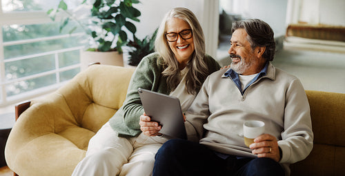 Senior couple using a tablet together at home