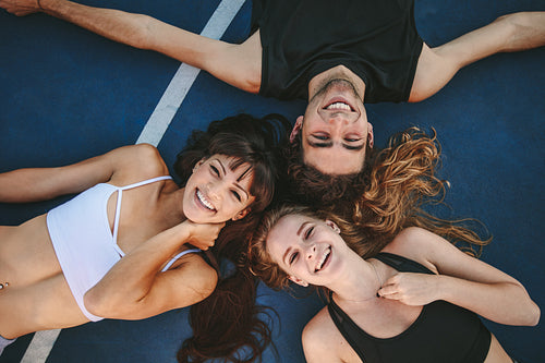 Friends relaxing on a basketball court