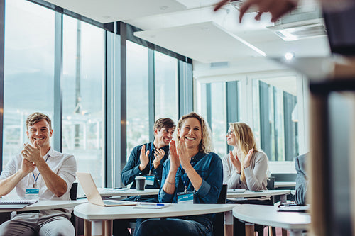 Businesspeople clapping hands in seminar