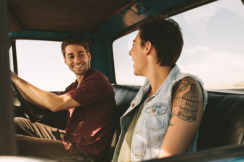 Young couple on a road trip driving in car