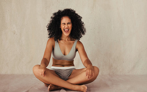 Winking female model having fun in her natural body