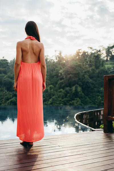 Woman standing at the poolside of holiday resort