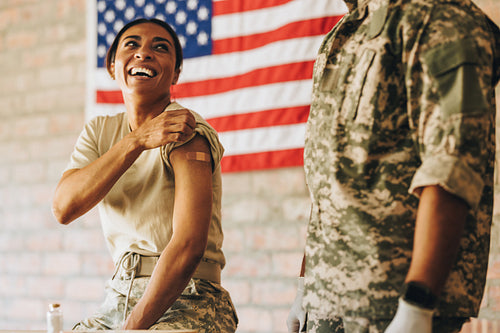 United States servicewoman smiling happily after getting vaccina
