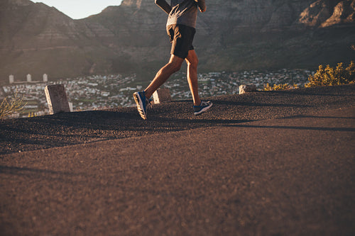 Young man running on country road