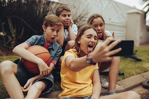 Group of friends having fun sitting outdoors