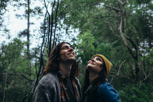 Couple looking up at the trees in rainforest