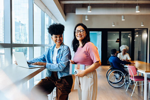 Women colleagues working together in a modern office