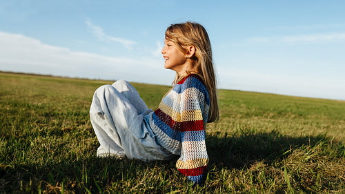 Young girl in field enjoying peace and freedom.