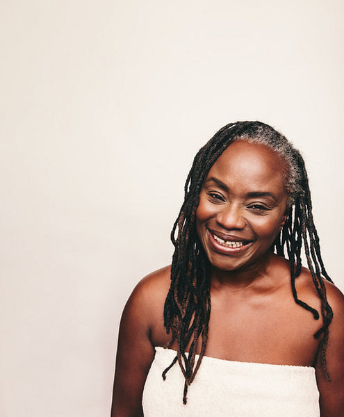 Mature woman smiling happily in a bath towel