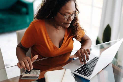 Elderly woman calculating her personal finances after retirement