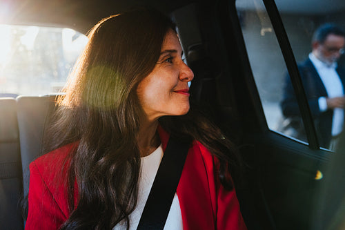 Professional woman in a car looking content and focused on her surroundings