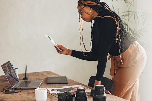 Photographer looking at a photograph in her office