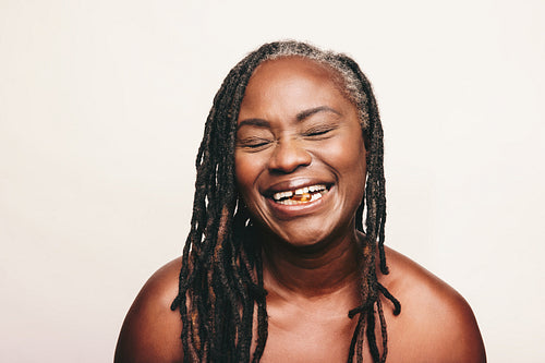 Cheerful woman taking a capsule of Omega 3 fatty acids