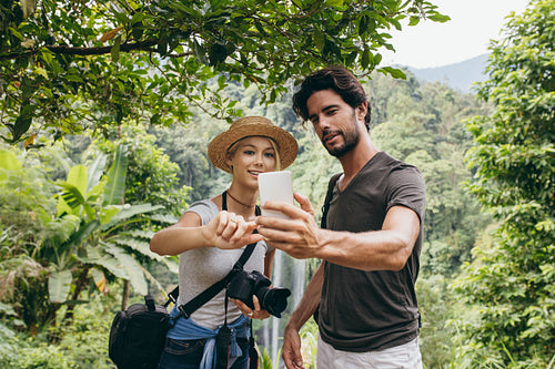Couple taking a self portrait in forest