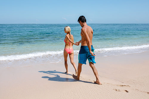 Young couple going for swim in sea