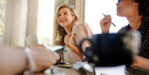 Smiling woman in meeting with colleagues