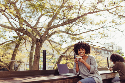 Woman drinking coffee outdoors