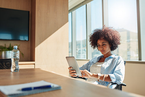 Creative businesswoman using tablet pc in office