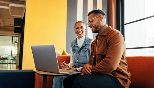 Colleagues working together in an office lobby
