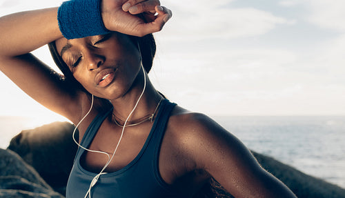 Tired female relaxing after intense workout.