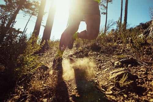 Man running down a rocky mountain slope