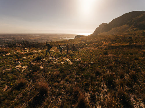 Four people walking in countryside