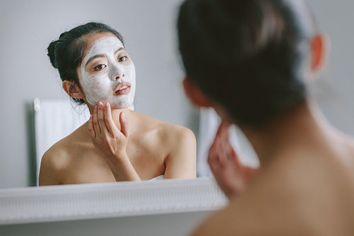 Woman doing beauty treatment in bathroom