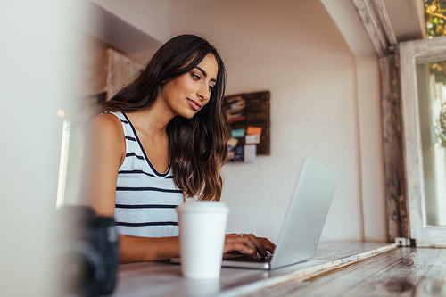 Woman working on laptop computer at home
