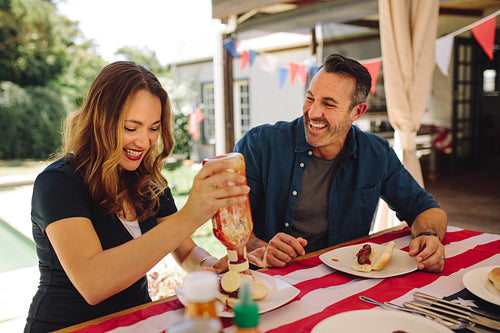 Smiling couple having fun dining