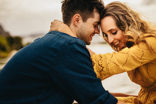Close up of a smiling couple in love sitting together