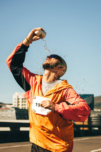 Energetic marathon runner cooling off during intense race