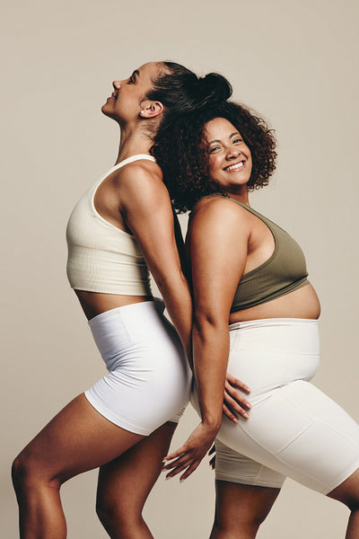 Fitness models embracing their toned bodies as they stand in sportswear