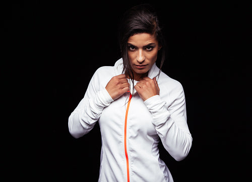 Confident young woman wearing sports jacket