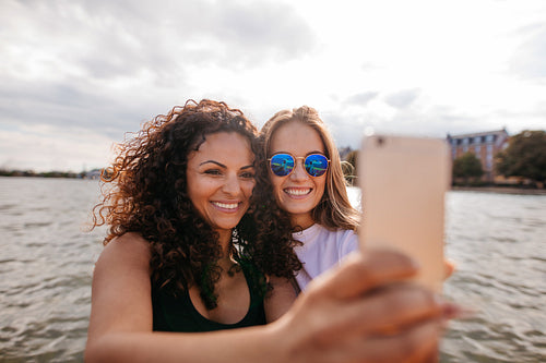 Attractive young women smiling and taking selfie