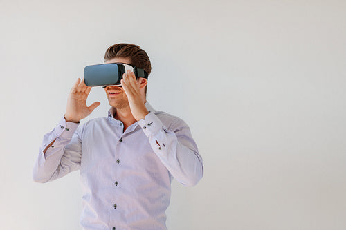 Young woman looking at the objects with VR headset