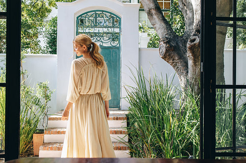 Happy female tourist standing outdoors in a fashionable summer d