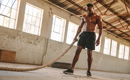 Man taking rest after battle rope workout